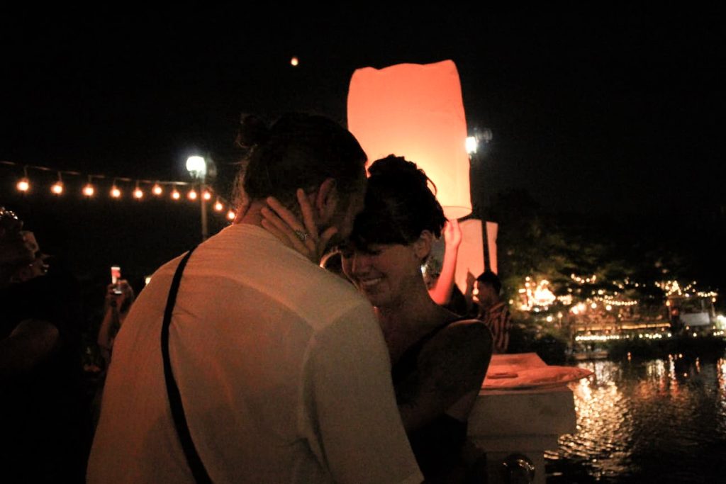 Couple at Yi peng lantern festival in Thailand.  Off-the-beaten-path attractions in Thailand. 
