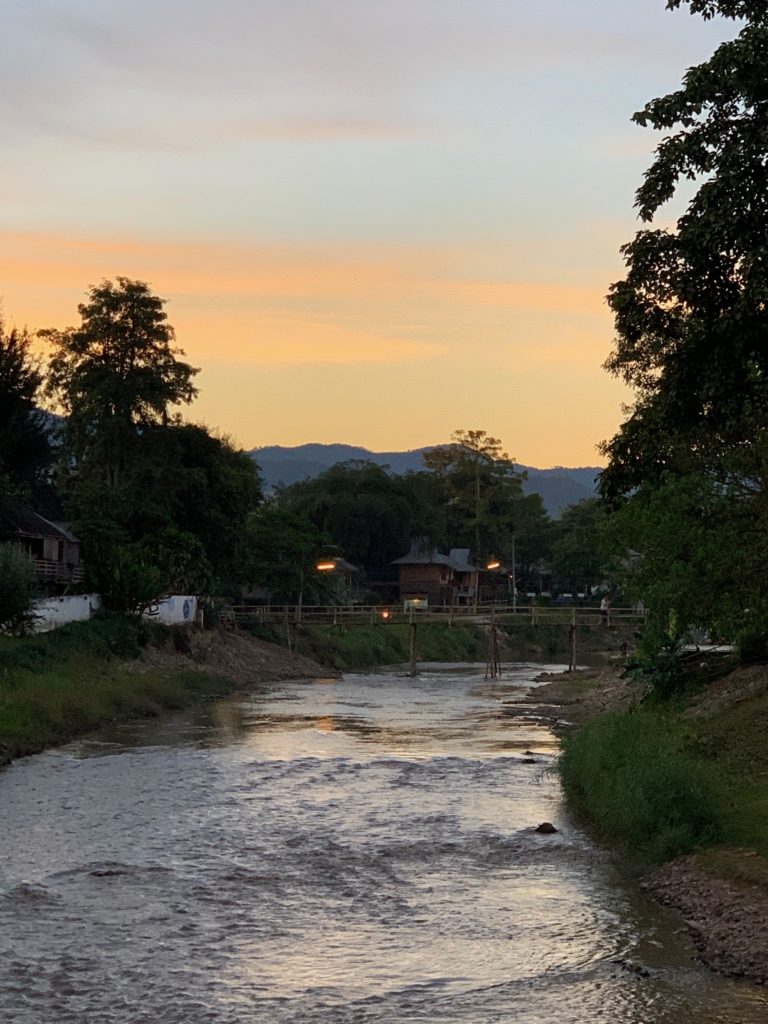 River at sunset in Pai Thailand. Bridge over small river. 