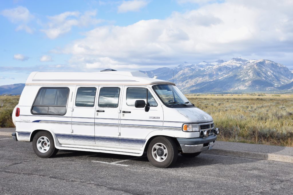 van sitting in mountain field. Camping in National Parks 