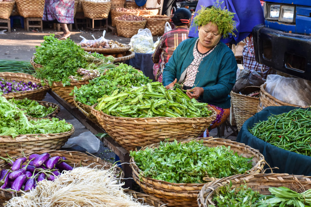 Woman selling green vegetables in baskets Cultural travel 