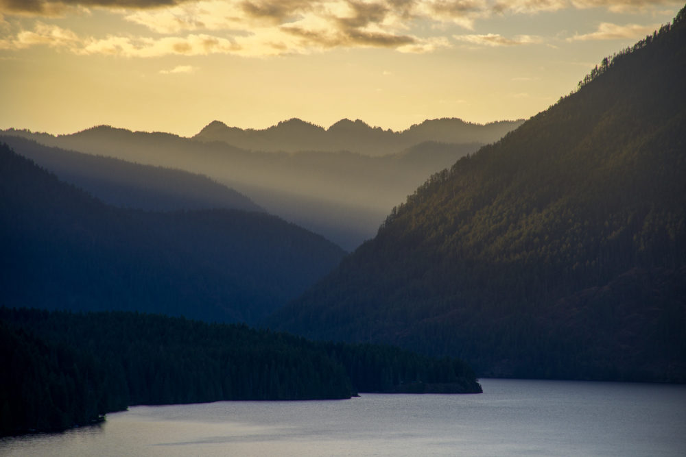 layers of mountains and a lake down below at golden hour. Tips for Olympic National Park