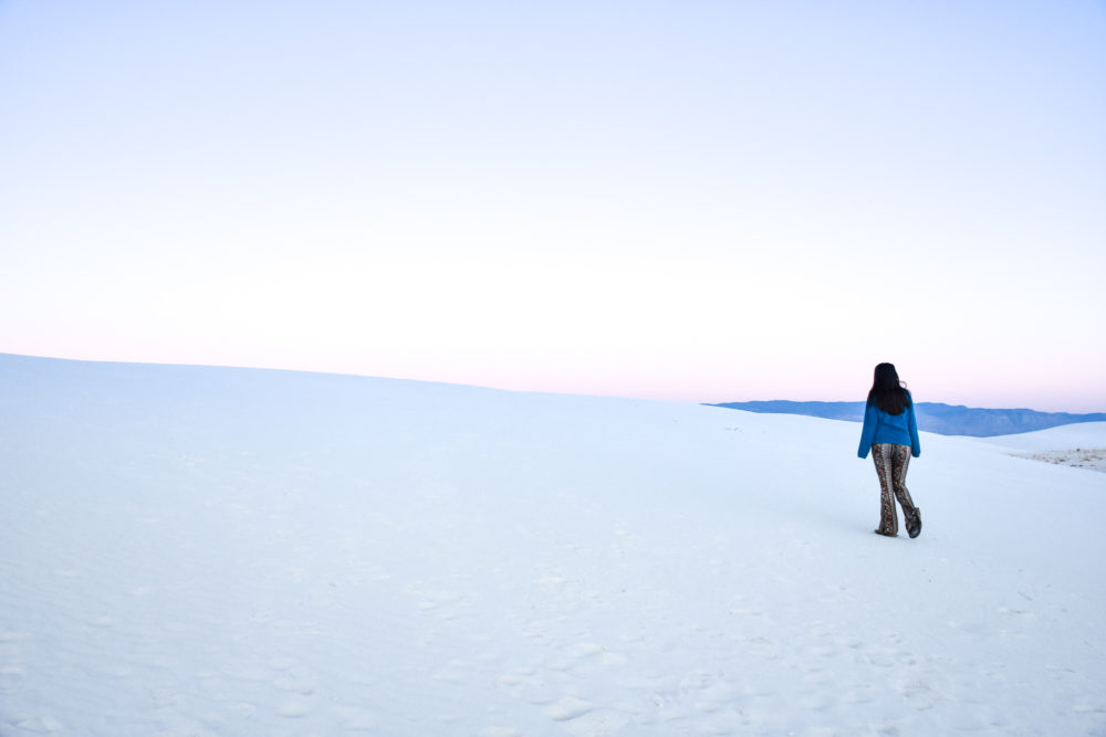 woman walking on the white sand in White Sands National Park. Guide to New Mexico. 