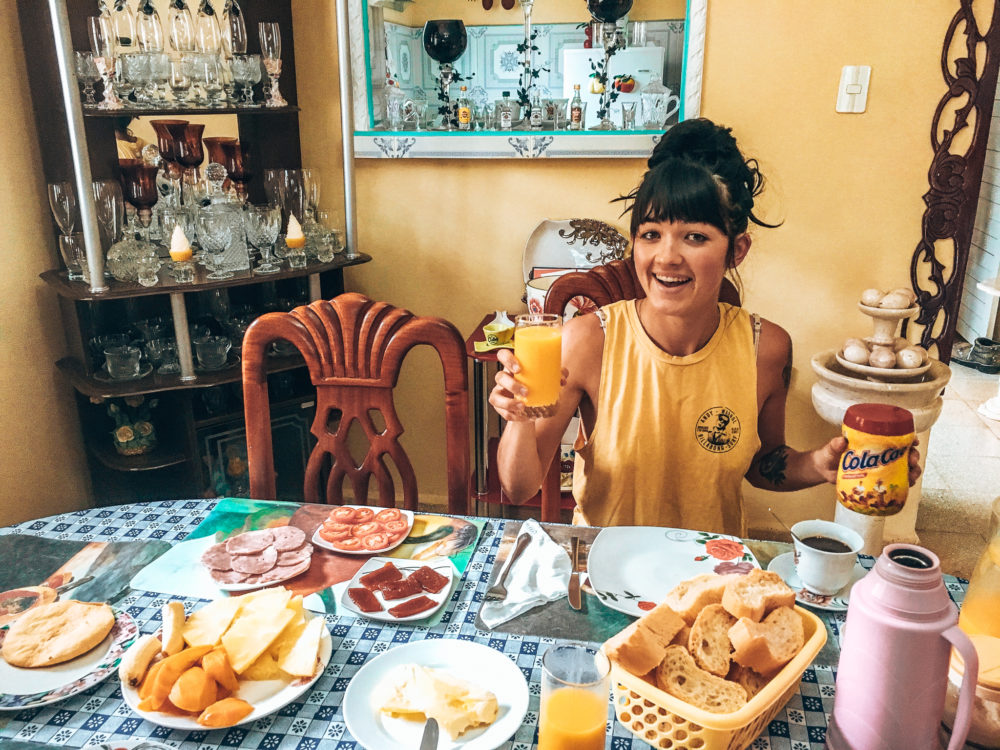 woman sitting a table eating a huge breakfast 