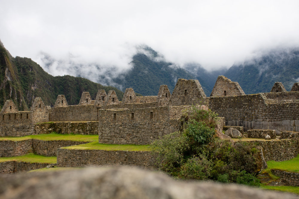 Machu Picchu Incan sites with mountains in the background. 