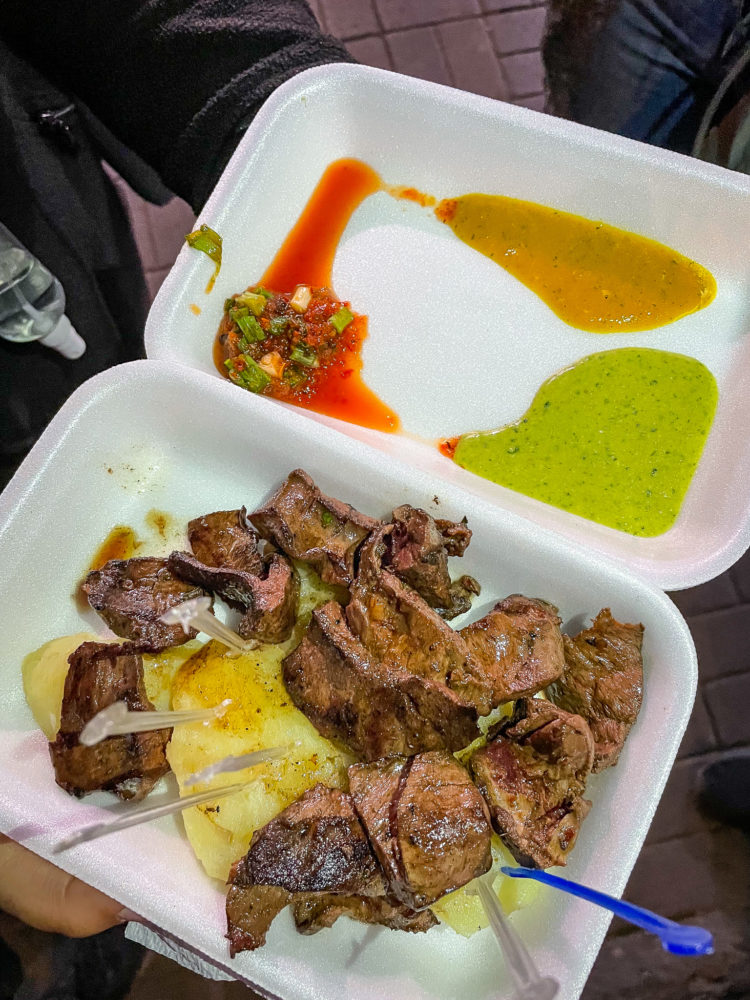 Anticuchos on a to go plate. Beef heart. Peruvian street food. 