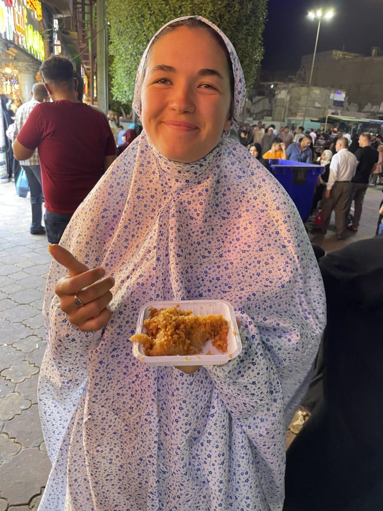 Wearing an abaya and snacking. 