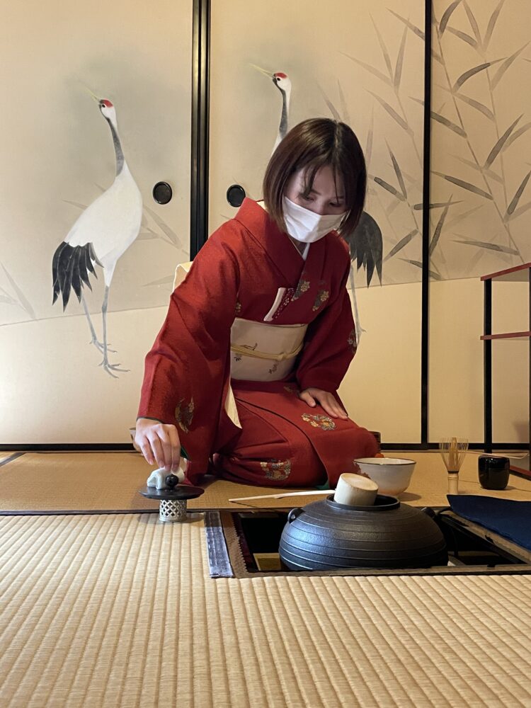 a woman in kimono preparing the match tea 