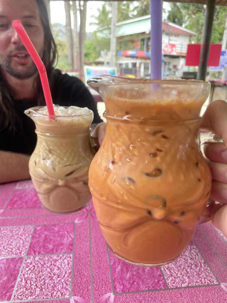 Two large cups of Thai Tea and coffee. 