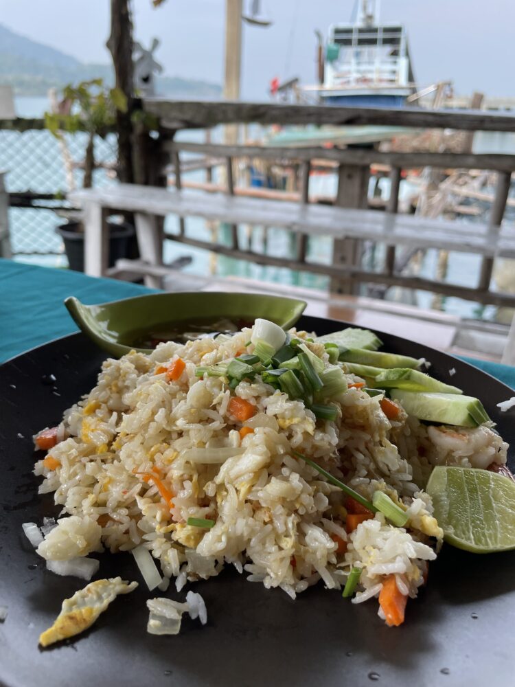 a plate of fried rice being eaten over the water in Koh kood guide. 