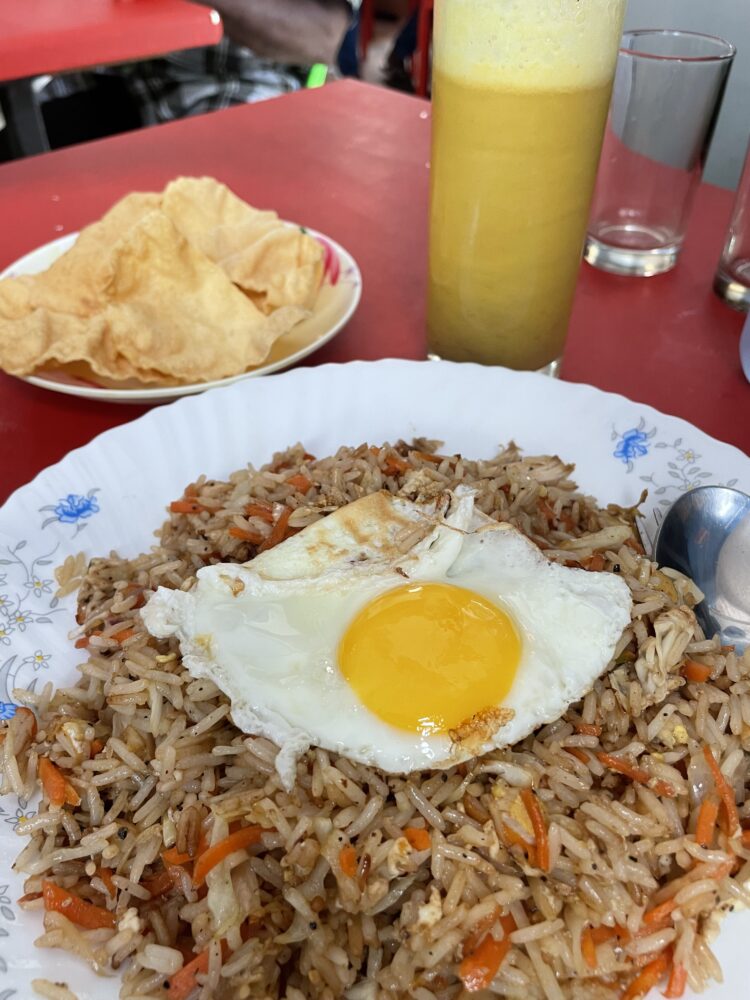 Tuna fried rice with an egg on top and mango juice 