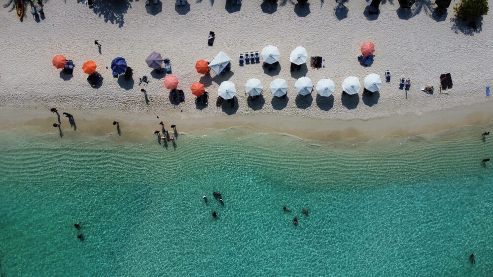Beach with lots of umbrellas and bright blue water