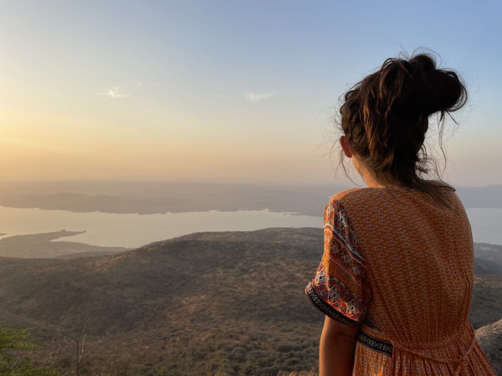 Overlooking a lake at sunrise on the Palitana Temple hike 