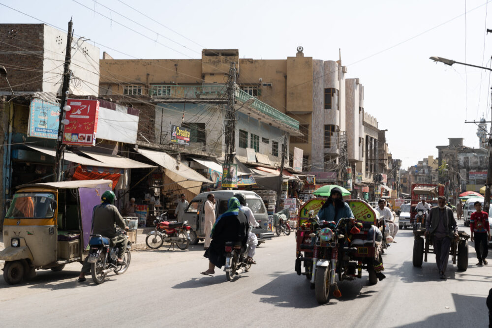 busy street in Lahore, Pakistan with many motorbikes on the road 