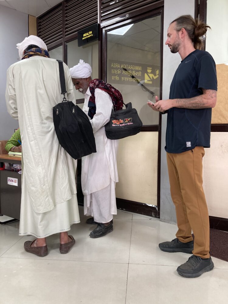 Man standing in line inside a customs office. 