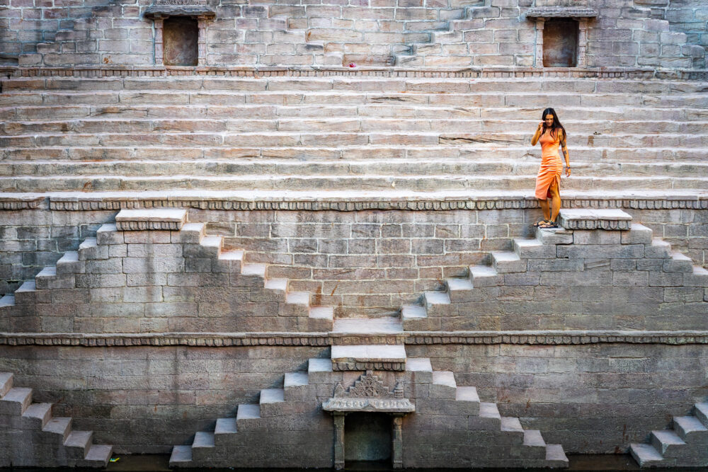Woman walking down a step well in Jodhpur. 