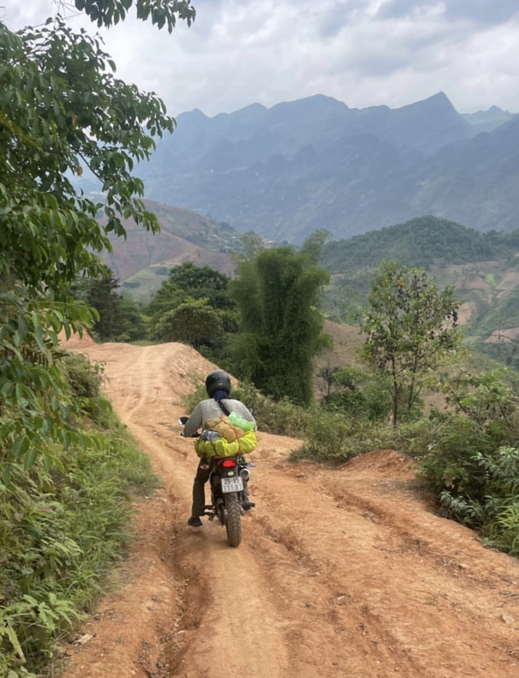 man on a dirt path on a motorcycle 