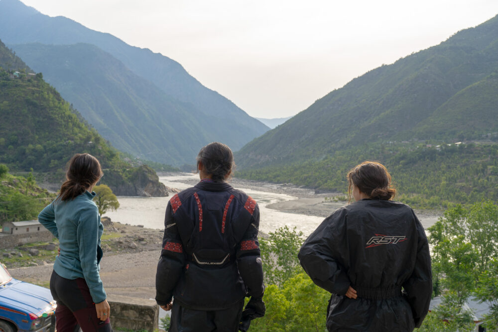 Three women overlooking the green Indus River Valley 