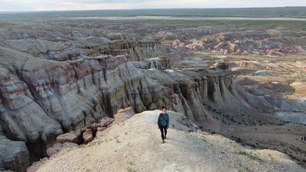 Woman walking on the top of the white stupa in Mongolia 