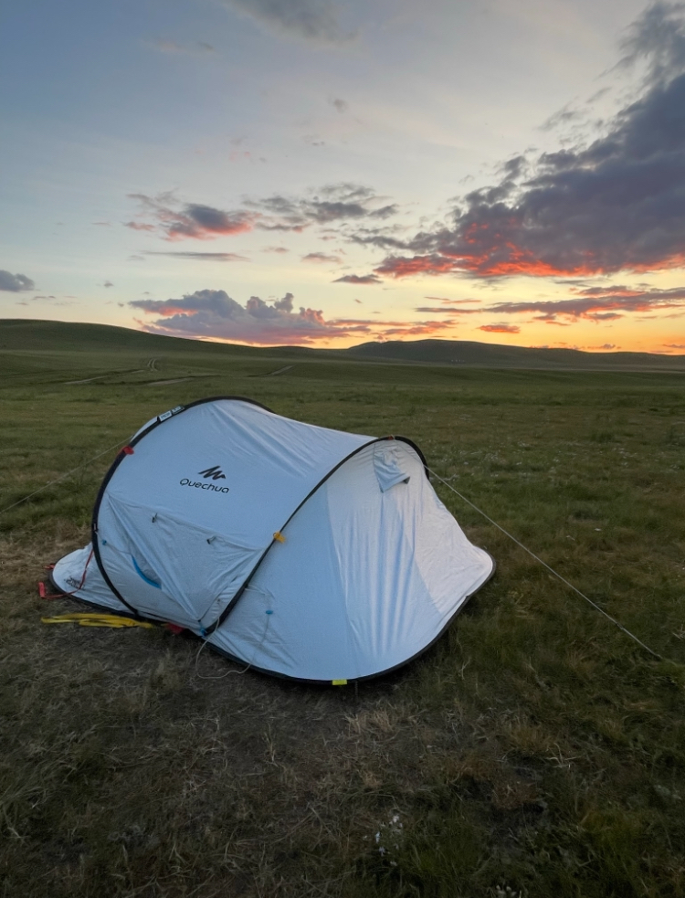White tent on a grassy field in Hustai National Park 