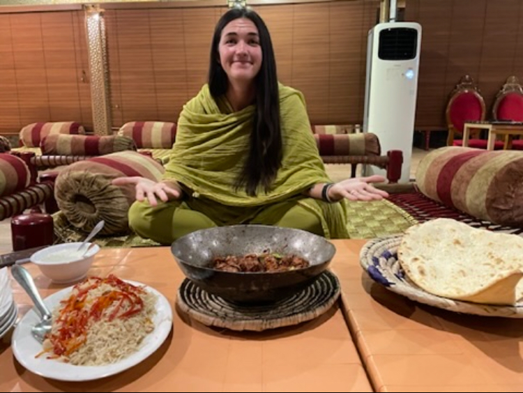 Me posing near a pile of delicious pakistani food 