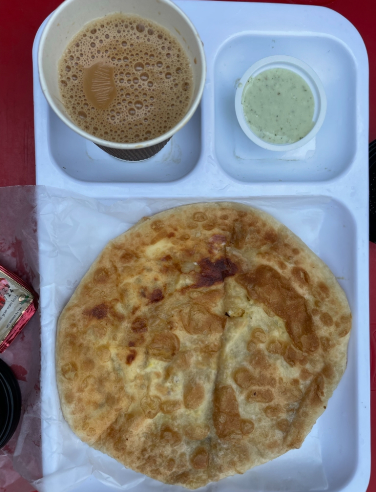 paratha and chai on a tray 