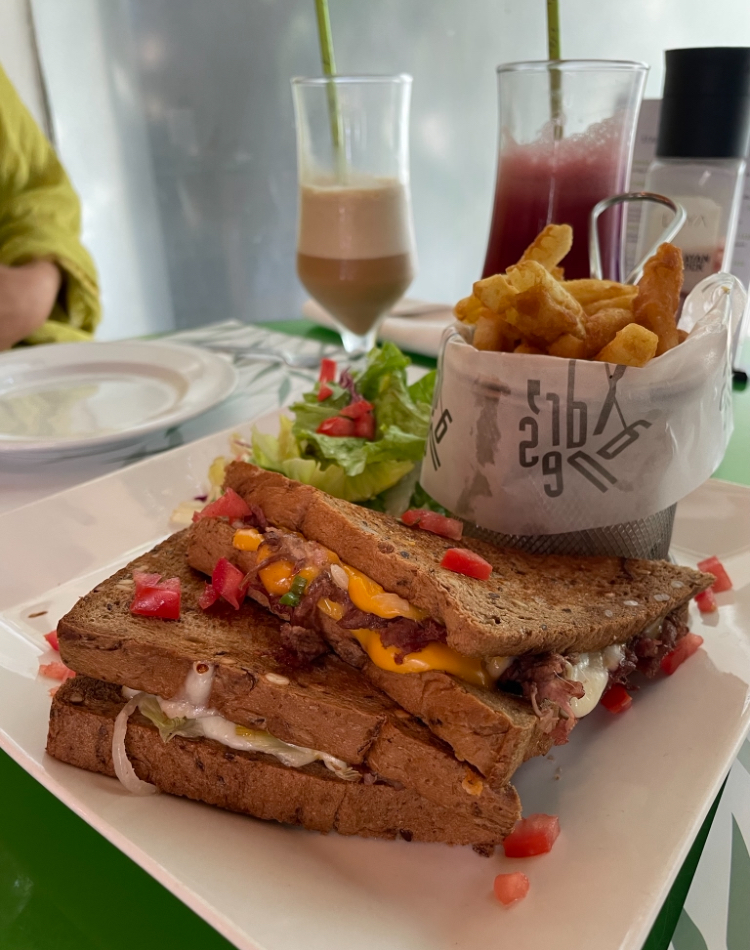 a sandwhich and french fries in a fancy cafe, Pakistan Foodie Guide