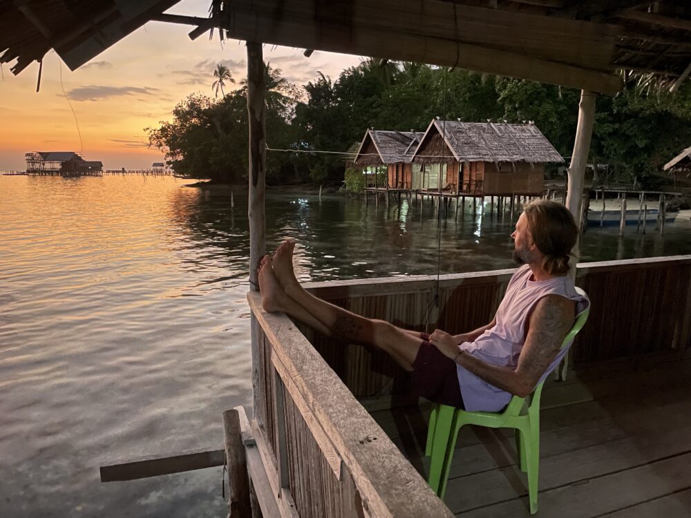 relaxing in our thatched overwater hut in raja ampat 