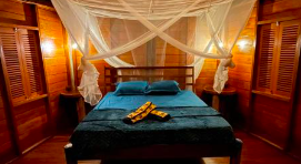 Bed inside a thatched room in Raja Ampat 