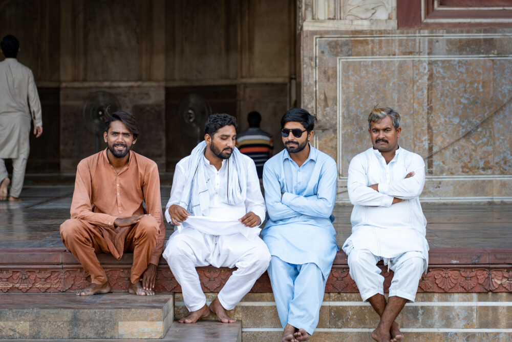 four pakistani men at a mosque 
