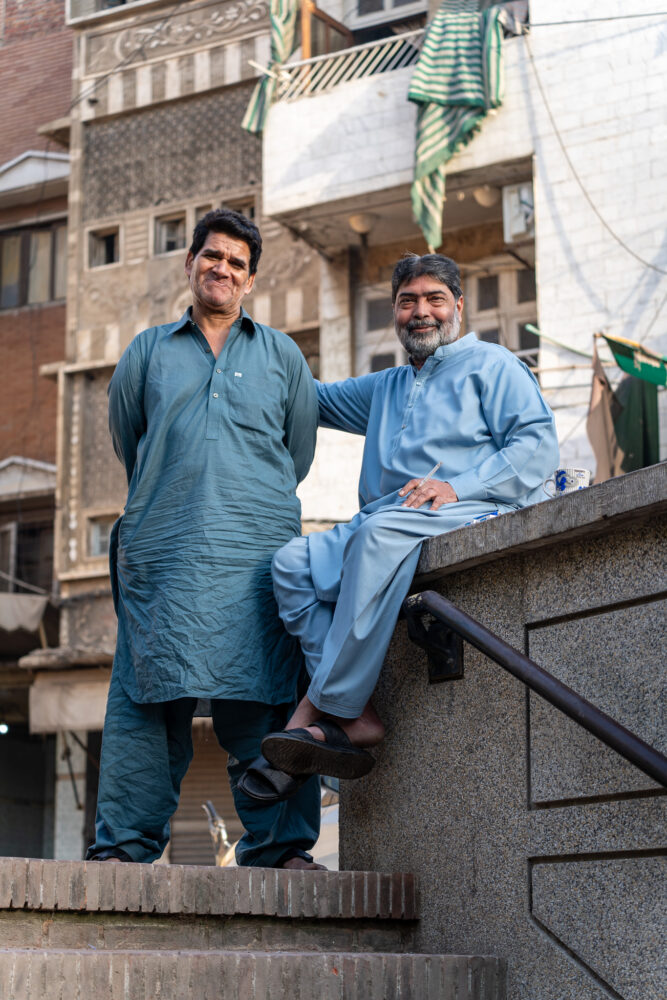 two men smiling wearing shalwar kameez 
