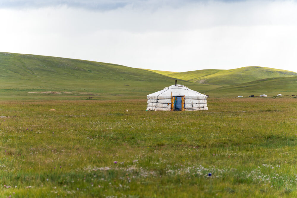 Mongolian traditional ger in the middle of an empty field 