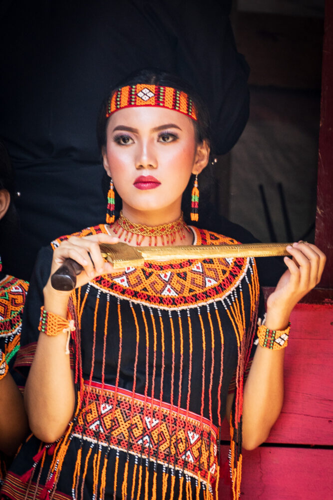 woman in traditional dress holding a knife 