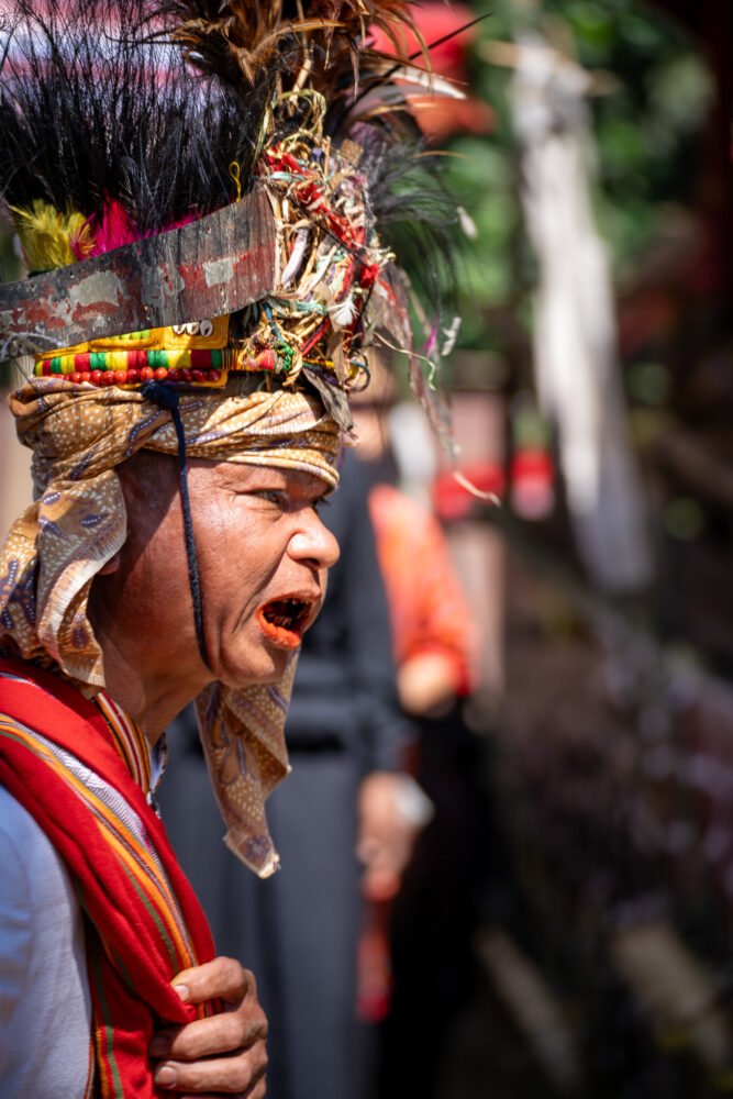 feathered headdress on a man at a ceremony 