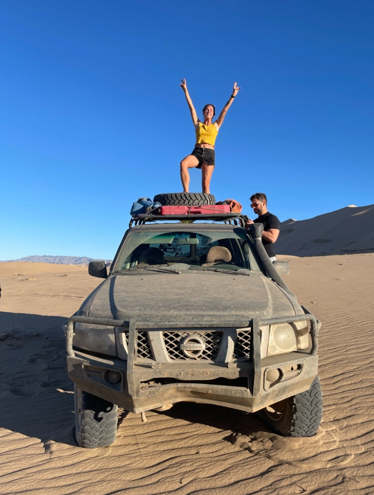 Me standing on top of our 4x4 in the desert 