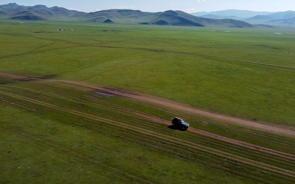 car driving through the green valleys of  self drive Mongolia itinerary 