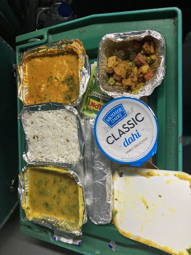 a meal on a train that consists of curry and yogurt