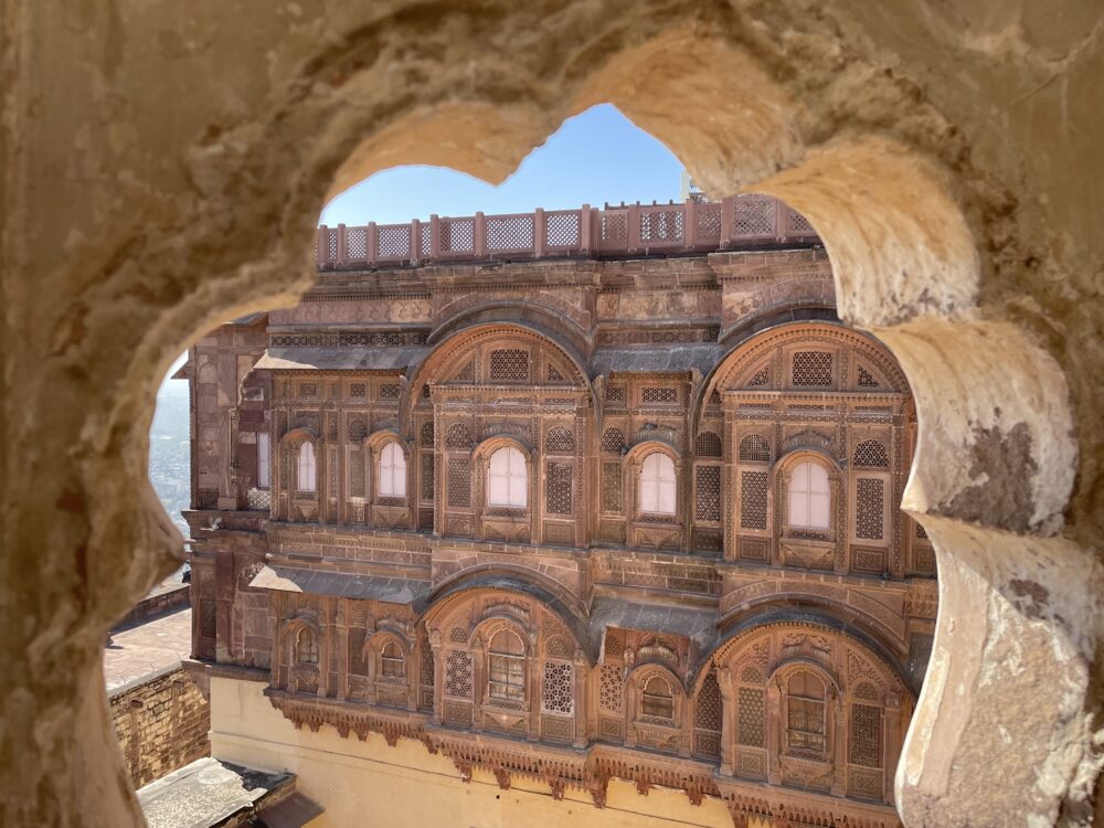 intricate red fort as seen through an archway in India