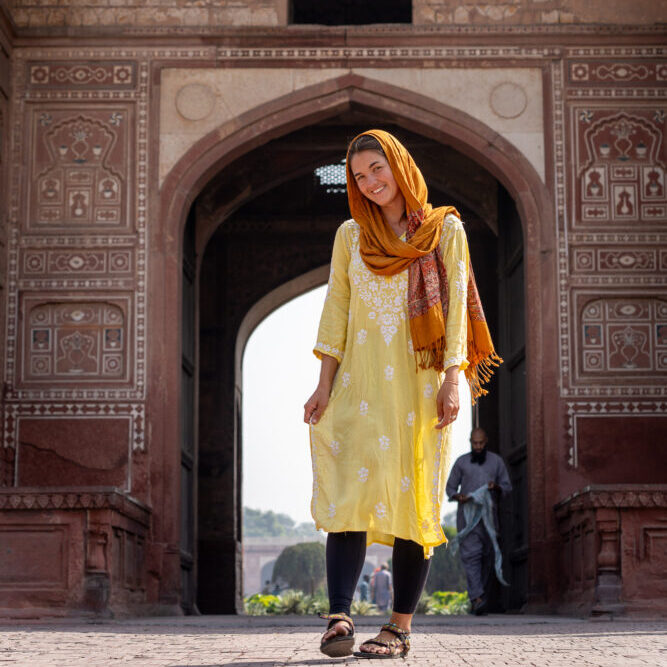 me in yellow traditional outfit in front of a mosque 