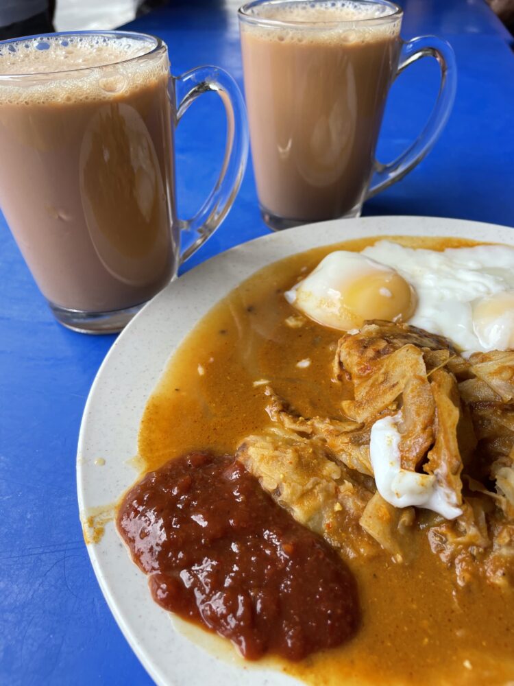 an egg dish with fiery sauces and coffee on the side 