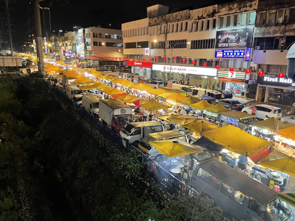 yellow tents stretching on as far as the eye can see at a night market in best places to eat in Kuala Lumpur