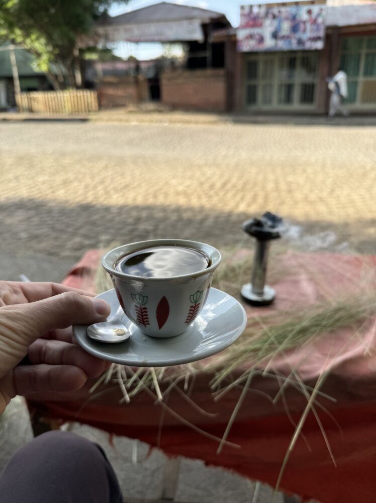 cup of coffee served with frankensence burning in the background