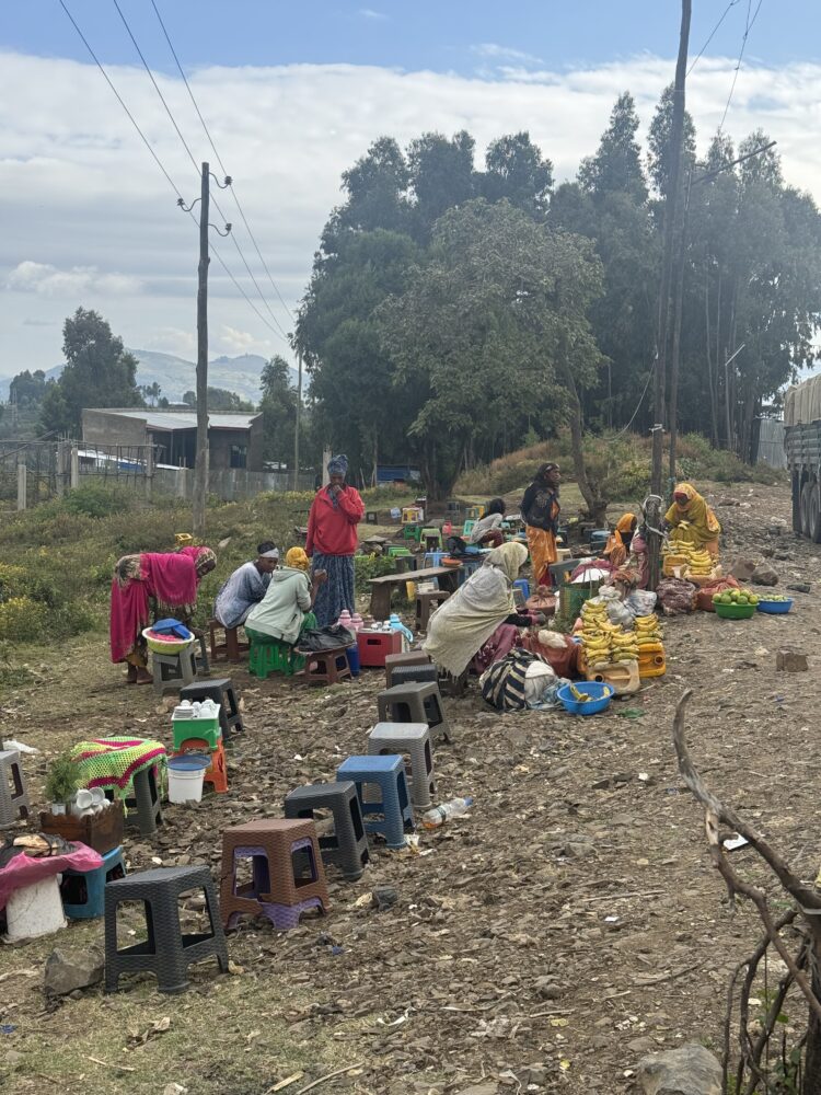 a bunch of tiny stools on the side of the road where street vendors sell bread and fruit