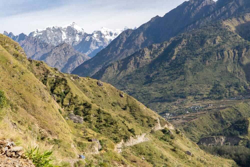 layers of mountains on the Manaslu circuit with a small village in view