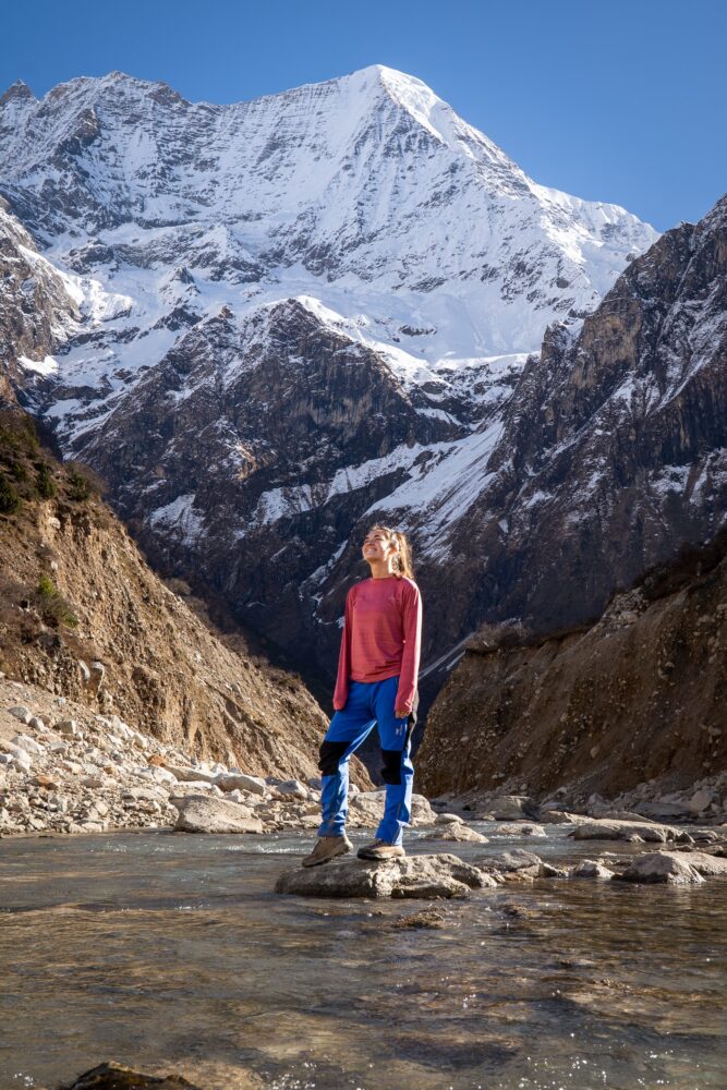 Me posing in front of the snowy mountains of nepal