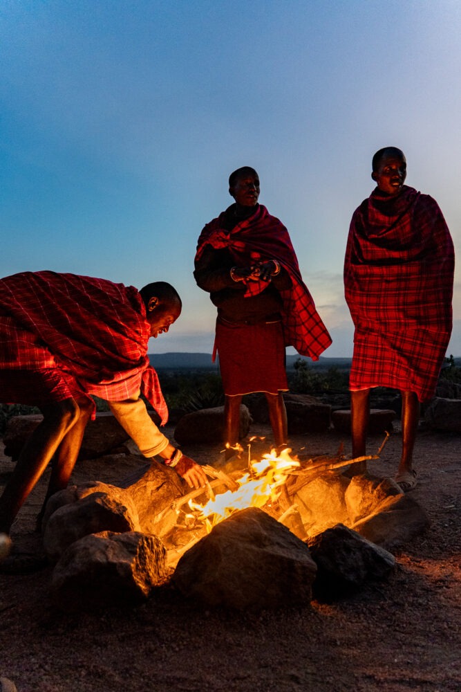 three maasai light a fire 