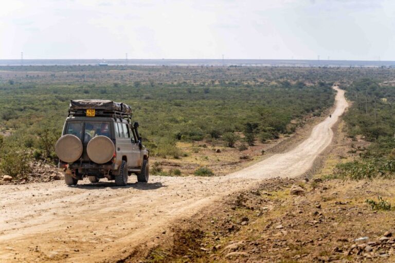 safari car on a lonely dirt road in Kenya